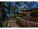 Landscaped backyard featuring a hot tub, patio, garden beds, and stone pathways for a tranquil retreat at 11760 Ashley Ct, Seminole, FL 33772