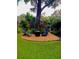 Backyard fire pit area with Adirondack chairs, perfect for outdoor gatherings at 11760 Ashley Ct, Seminole, FL 33772