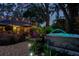 Backyard view with hot tub, patio, garden area, and decorative lighting enhancing outdoor living at 11760 Ashley Ct, Seminole, FL 33772