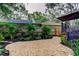 Backyard landscape with a rock garden, palm trees, and a decorative privacy fence at 11760 Ashley Ct, Seminole, FL 33772