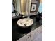 Bathroom vanity featuring marble vessel sink and black countertop at 11760 Ashley Ct, Seminole, FL 33772