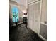 Detailed view of a bedroom showcasing an elegant accent table, artwork and plantation shutters at 11760 Ashley Ct, Seminole, FL 33772