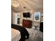 Bedroom with elegant chandelier, modern TV, and sleek black and white striped carpet at 11760 Ashley Ct, Seminole, FL 33772