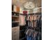 Well-organized walk-in closet featuring custom shelving, hanging racks, and luxury goods at 11760 Ashley Ct, Seminole, FL 33772