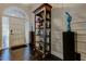 Inviting foyer featuring hardwood floors, elegant shelving, and an arched transom window at 11760 Ashley Ct, Seminole, FL 33772
