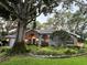Charming home with manicured landscaping, large front tree and inviting curb appeal at 11760 Ashley Ct, Seminole, FL 33772