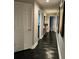 Hallway featuring dark wood floors and white trim at 11760 Ashley Ct, Seminole, FL 33772