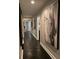 Hallway featuring dark wood floors and decorative art at 11760 Ashley Ct, Seminole, FL 33772