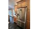 Kitchen area featuring stainless steel refrigerator and wooden cabinets at 11760 Ashley Ct, Seminole, FL 33772