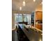 Kitchen area with a counter, bar stools, stainless steel appliances, and shutters at 11760 Ashley Ct, Seminole, FL 33772