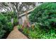 Lush landscaping with a winding gravel path leading to the home's exterior at 11760 Ashley Ct, Seminole, FL 33772