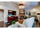 Inviting living room featuring brick fireplace, large TV, and white couch at 11760 Ashley Ct, Seminole, FL 33772