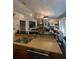 Inviting open concept living space with kitchen island, brick fireplace, and large TV at 11760 Ashley Ct, Seminole, FL 33772