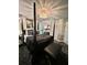 Luxurious main bedroom featuring elegant chandelier, four-poster bed, and sophisticated decor with private access at 11760 Ashley Ct, Seminole, FL 33772