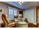 Inviting office space with a glass desk, comfortable executive chair, and bright shutters providing natural light at 11760 Ashley Ct, Seminole, FL 33772