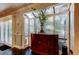 Sunroom with a cabinet, plenty of windows, and dark wood floors at 11760 Ashley Ct, Seminole, FL 33772
