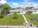 Aerial view of property showcasing the home, well-kept lawn, and direct access to waterfront canal at 13316 Carol Dr, Hudson, FL 34667