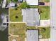Aerial view showing the home's canal access, boat dock, well-maintained lawn, and convenient parking at 13316 Carol Dr, Hudson, FL 34667