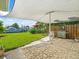 Spacious backyard with a patio, grill, lush lawn, and a waterfront view with a boat at 13316 Carol Dr, Hudson, FL 34667
