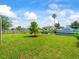 Beautiful waterfront backyard with lush lawn, mature tree, and scenic canal view at 13316 Carol Dr, Hudson, FL 34667