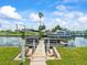 Waterfront dock featuring boat lift and easy access to the canal for boating and recreation at 13316 Carol Dr, Hudson, FL 34667