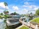 Waterfront dock featuring boat lift, providing convenient access to the canal for boating and recreation at 13316 Carol Dr, Hudson, FL 34667