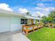 Charming single-story home with a covered front porch featuring wooden planter boxes at 13316 Carol Dr, Hudson, FL 34667