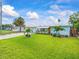 Lovely single-story home with spacious lawn, landscaping and inviting covered front patio at 13316 Carol Dr, Hudson, FL 34667