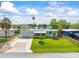 Charming single-story home with lush lawn, pretty landscaping, and a covered front porch at 13316 Carol Dr, Hudson, FL 34667