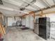 Spacious garage with ample storage shelving, a refrigerator, and a side entrance door at 13316 Carol Dr, Hudson, FL 34667