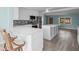 Open kitchen with white countertops, a large island, and views of the living area at 13316 Carol Dr, Hudson, FL 34667