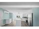 Bright kitchen featuring white cabinets, stainless steel appliances, and a center island at 13316 Carol Dr, Hudson, FL 34667
