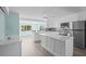 Modern kitchen with a large island, stainless steel appliances, and open layout at 13316 Carol Dr, Hudson, FL 34667
