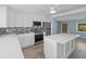 Modern kitchen with white cabinets, stainless steel appliances, and a tile backsplash at 13316 Carol Dr, Hudson, FL 34667