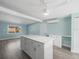 Open-concept kitchen with a central island and blue wall at 13316 Carol Dr, Hudson, FL 34667