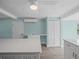 Bright kitchen featuring white cabinets, a closet, and a center island at 13316 Carol Dr, Hudson, FL 34667