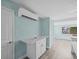 Light blue kitchen featuring white cabinets and drawers with stainless steel handles at 13316 Carol Dr, Hudson, FL 34667