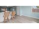 Open-concept living area with bar seating and views of the modern kitchen and bedroom entrance at 13316 Carol Dr, Hudson, FL 34667