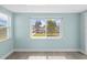Bright living room featuring a large window with views of the waterfront and modern flooring at 13316 Carol Dr, Hudson, FL 34667