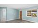 Bright living room with new floors, neutral paint, large window, and modern fixtures at 13316 Carol Dr, Hudson, FL 34667