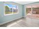 Light-filled living area featuring a sliding door to the patio and new vinyl plank flooring at 13316 Carol Dr, Hudson, FL 34667