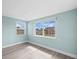 Bright living room with updated flooring and dual windows showing views of the neighborhood at 13316 Carol Dr, Hudson, FL 34667
