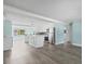 Open-concept living area with an island, new floors, stainless steel appliances and lots of natural light at 13316 Carol Dr, Hudson, FL 34667