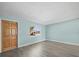 Bright, freshly painted living room with new floors, a large window, and stylish front door at 13316 Carol Dr, Hudson, FL 34667