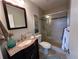 Modern bathroom with tiled shower, neutral walls, and granite countertop vanity at 1365 Snell Isle Ne Blvd # 6E, St Petersburg, FL 33704