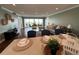 Bright living room with open layout, hardwood floors, and views of the water, next to dining and bar seating at 1365 Snell Isle Ne Blvd # 6E, St Petersburg, FL 33704