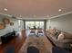 Bright living room boasts wood floors, recessed lighting, and a balcony with water views at 1365 Snell Isle Ne Blvd # 6E, St Petersburg, FL 33704