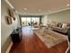 Bright living room featuring hardwood floors, comfortable seating, and access to the balcony at 1365 Snell Isle Ne Blvd # 6E, St Petersburg, FL 33704
