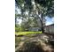 A large backyard with mature trees and a fire pit provides plenty of space at 14935 Ogden Loop, Odessa, FL 33556