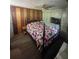 Cozy bedroom with wood accents, featuring a decorative quilt and vintage style furniture at 14935 Ogden Loop, Odessa, FL 33556